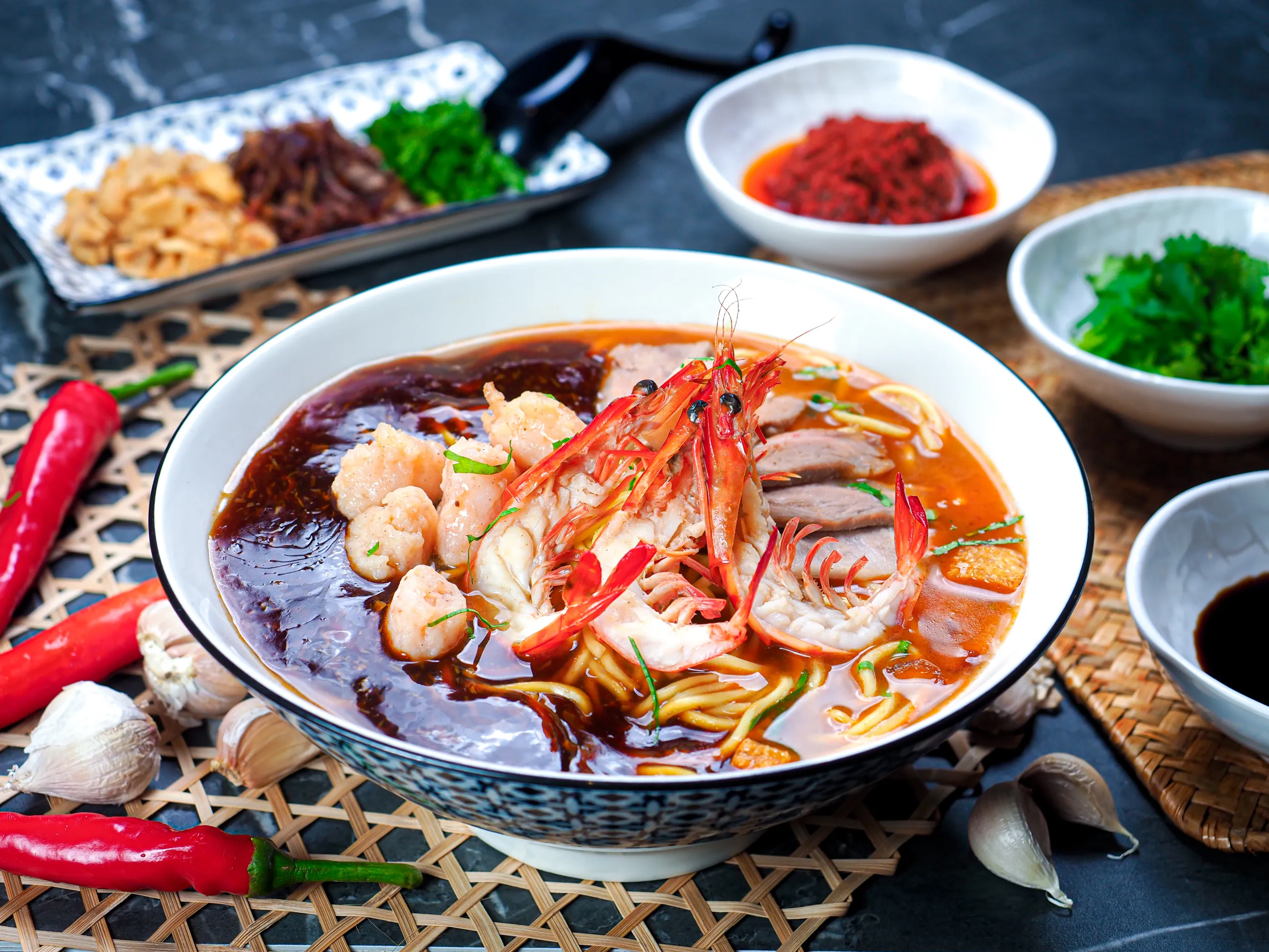 Prawn mee soup dark background hawker food photography Singapore