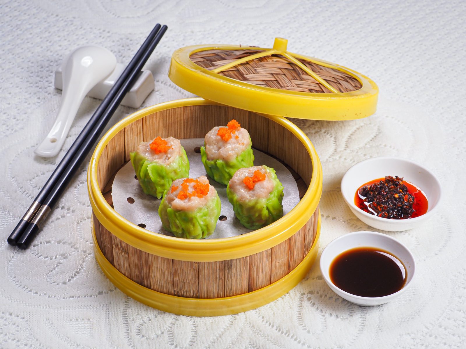 Siew mai pork dumplings with roe in bamboo steamer, dim sum food photography Singapore
