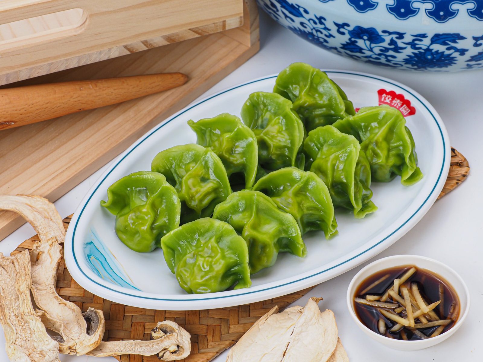 Steamed spinach dumplings on a plate with dried mushrooms, Chinese food photography Singapore